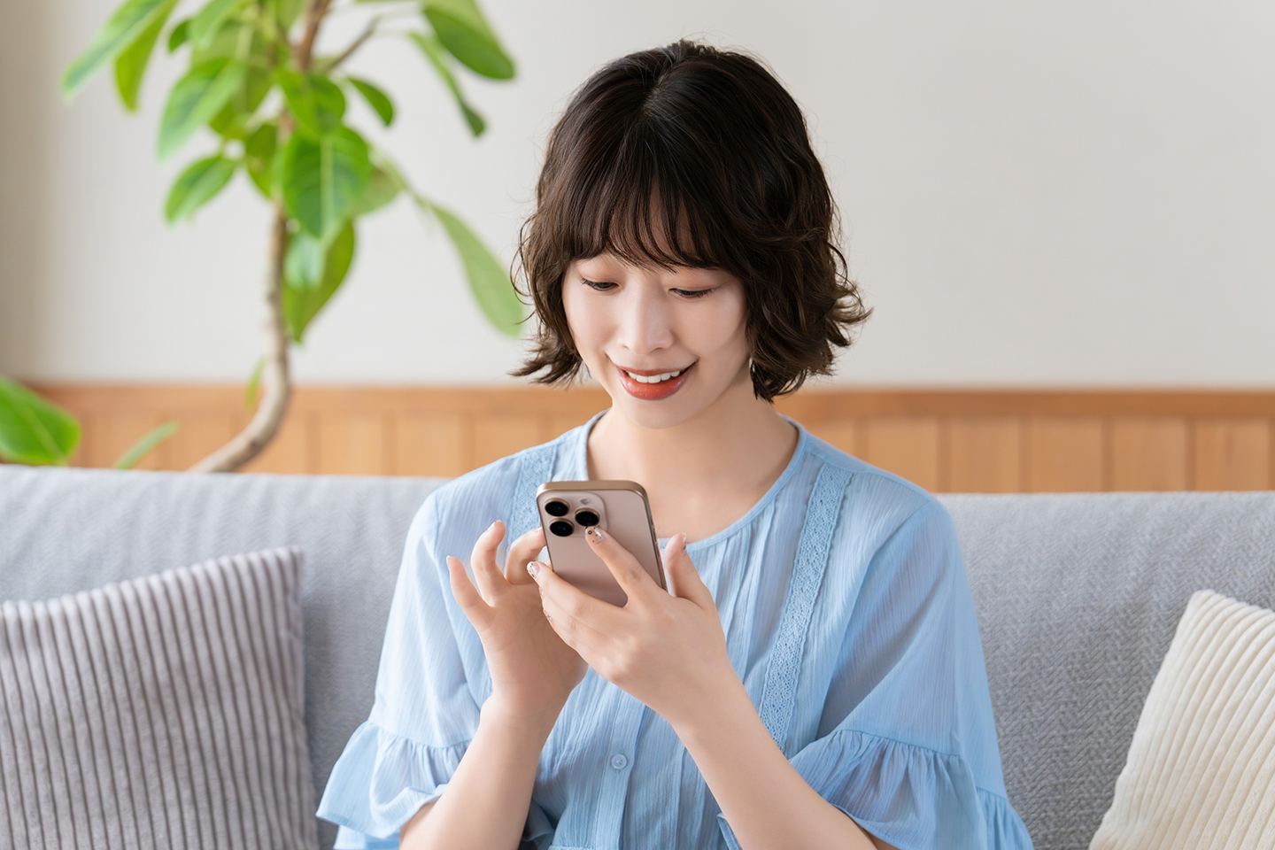 スマホを操作しながら副業に取り組む女性